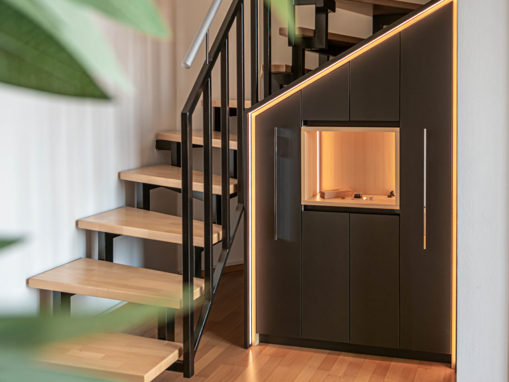 Custom stair cabinet solution in black with LED lighting