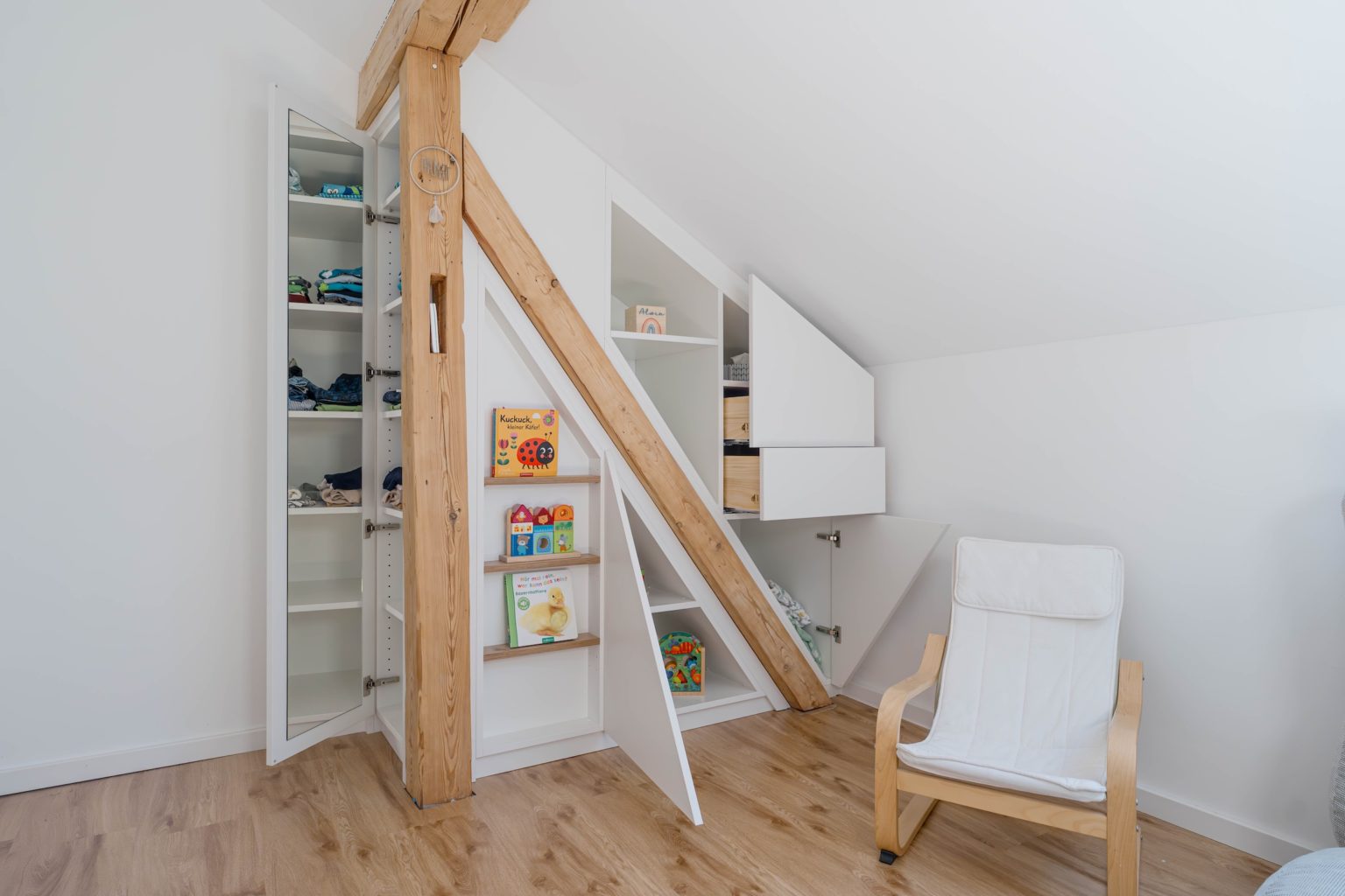 Sloping roof cupboard with integrated beam and open doors