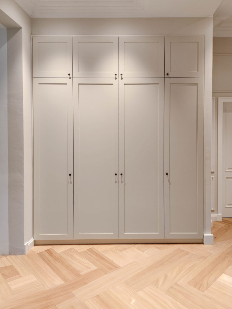 Custom-made beige fitted wardrobe with cassette front in the hallway