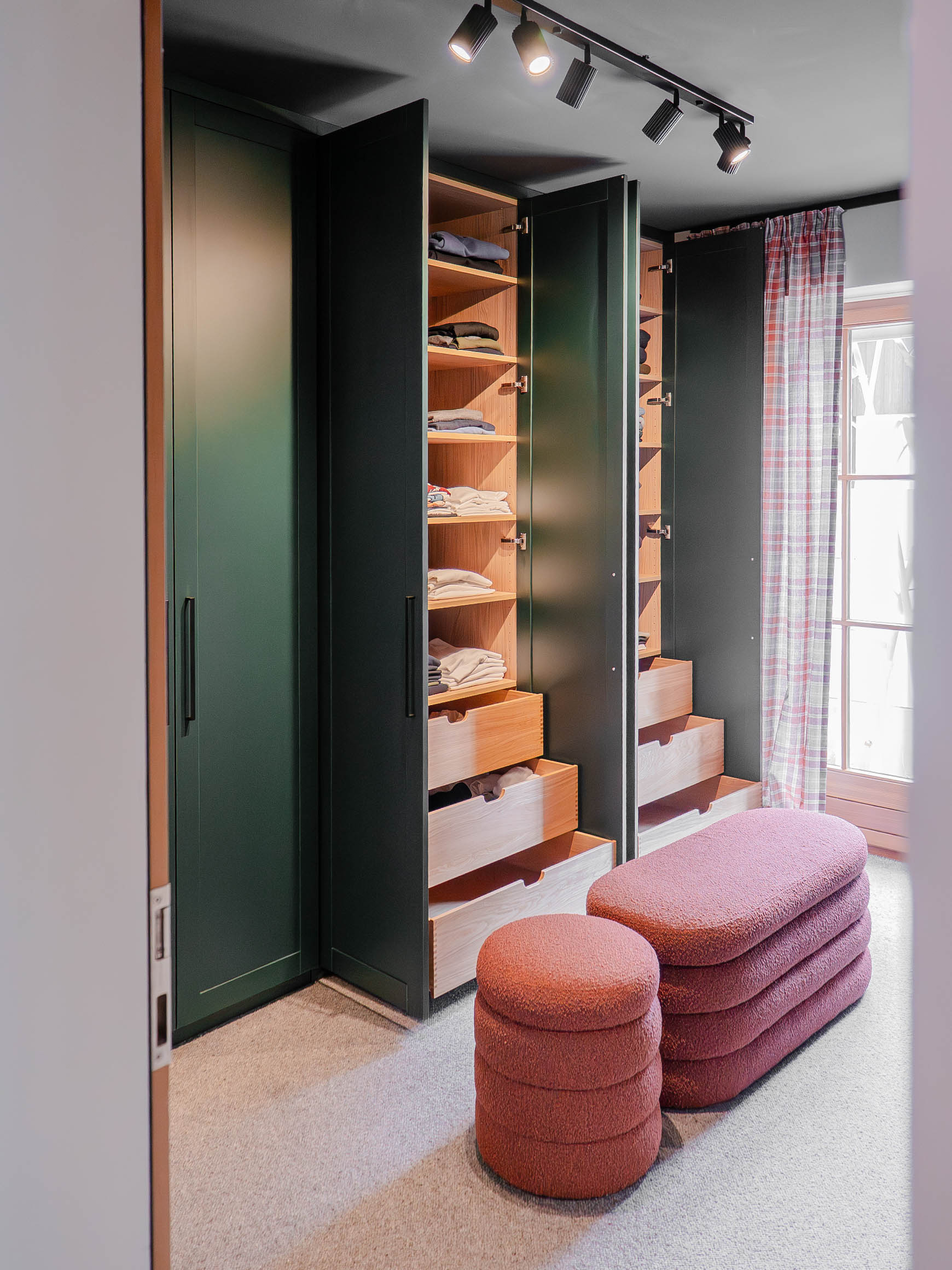 Custom-made dressing room with open green closet and integrated drawers