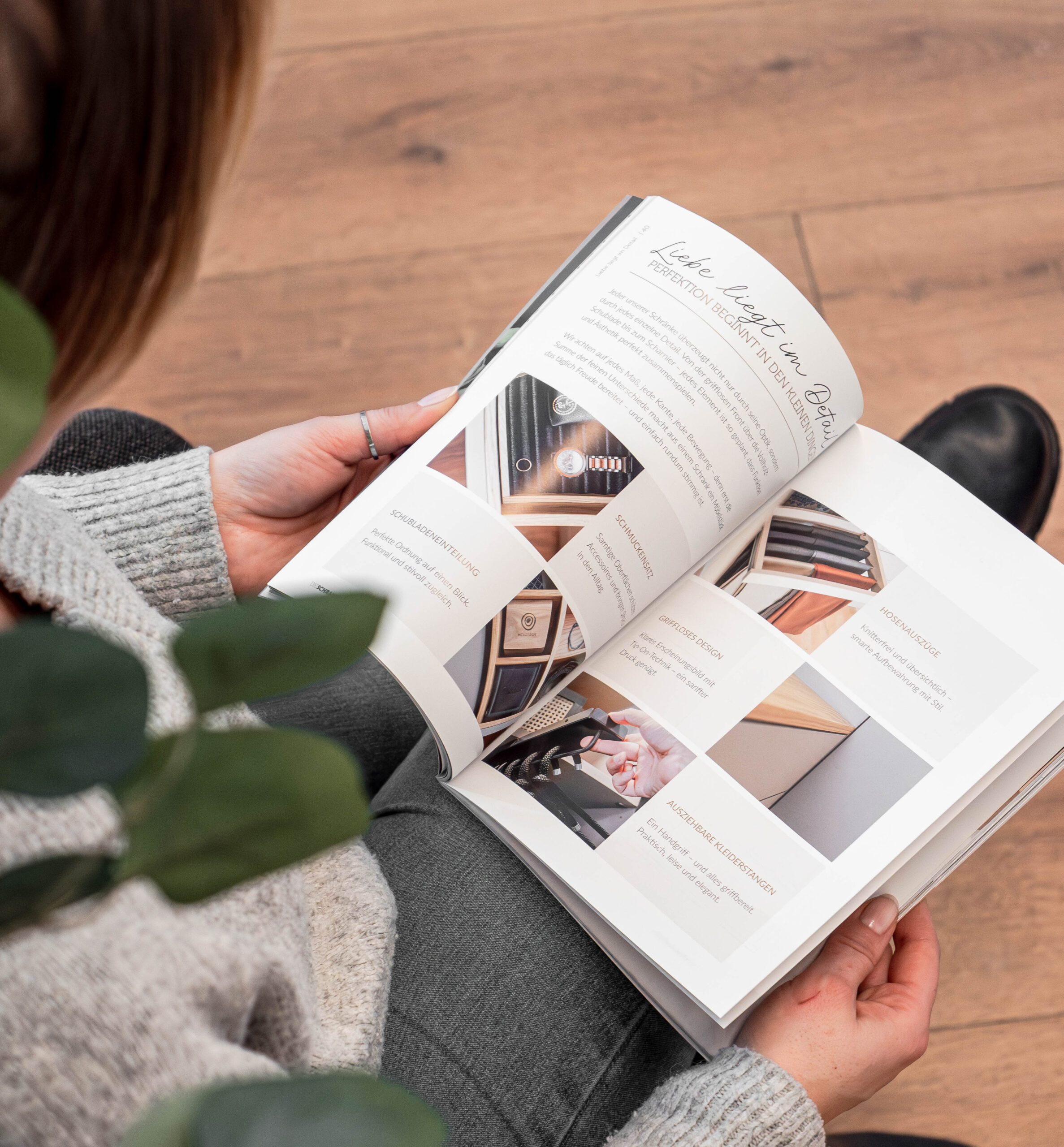 Opened Cabinetheroes magazine with detailed pictures in hand