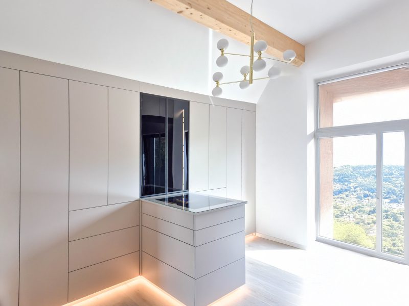 Custom-made dressing room with island, built-in wardrobe and integrated lighting