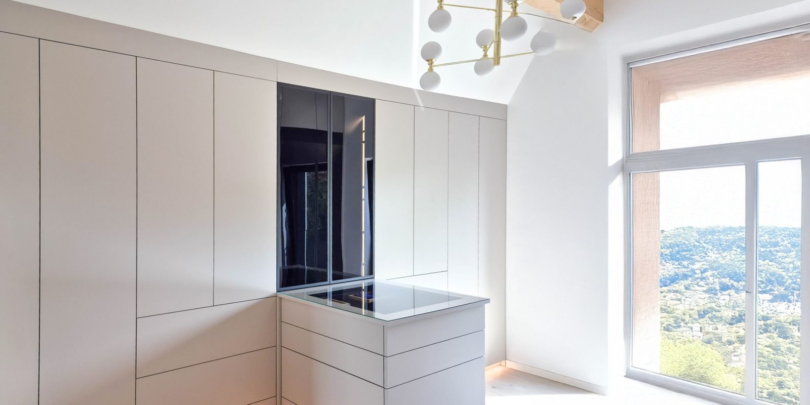 Custom-made dressing room with island, built-in wardrobe and integrated lighting