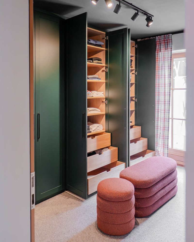 Custom-made dressing room with open green closet and integrated drawers
