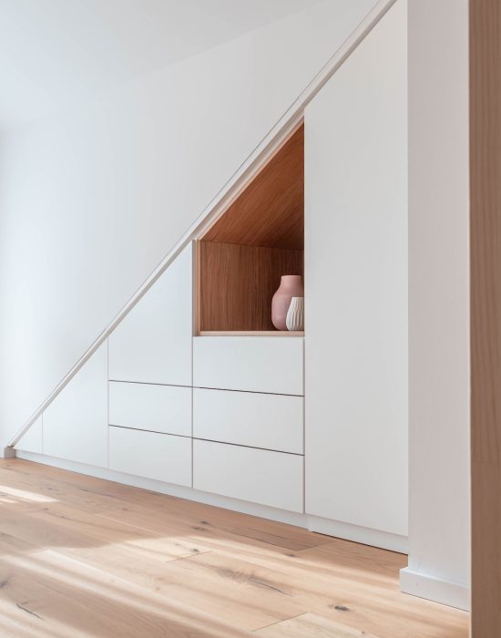 Walk-in sloping ceiling cupboard matt white inlay oak LED motion detector