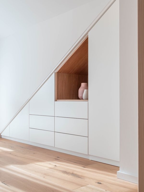 Walk-in sloping ceiling cupboard matt white inlay oak LED motion detector