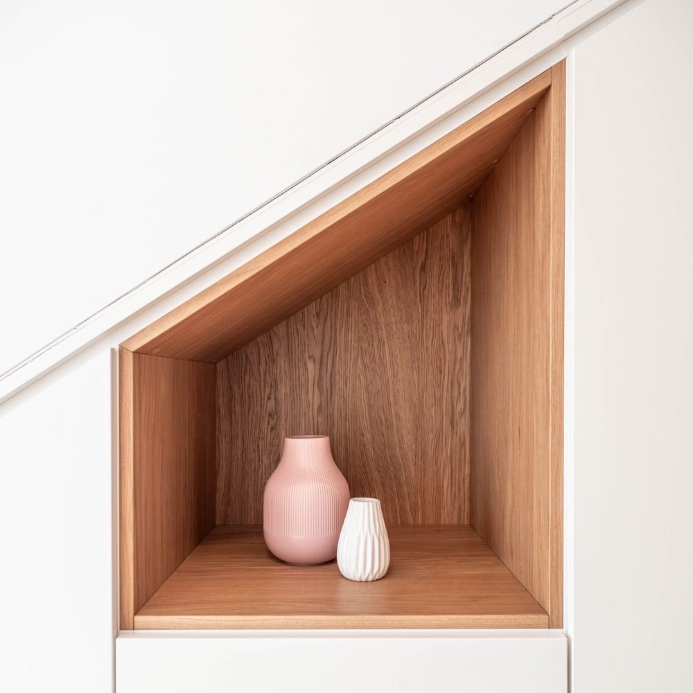 Walk-in sloping ceiling cupboard with oak inlay