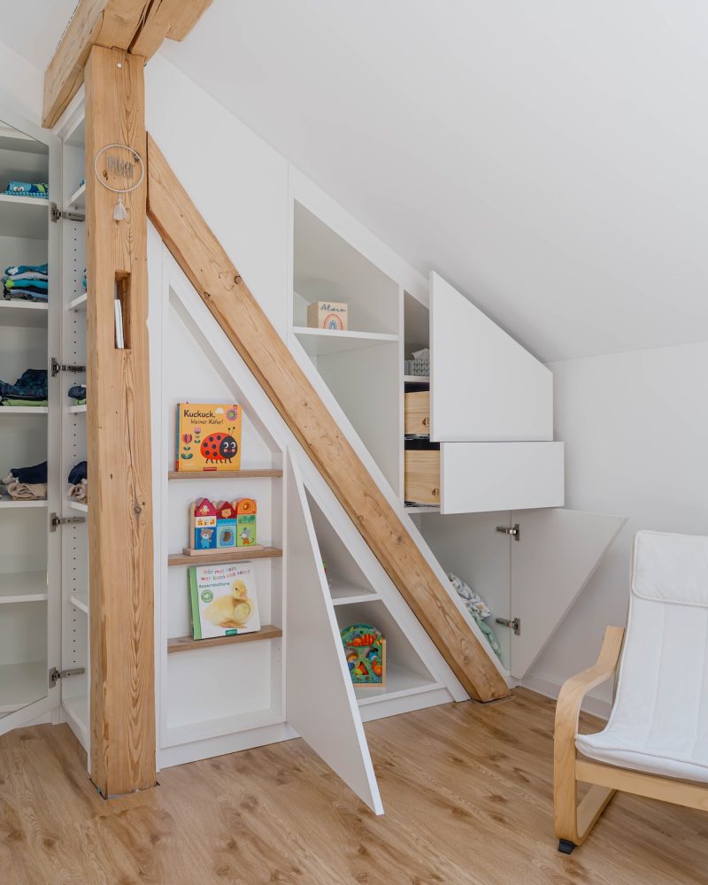 Sloping roof cupboard with integrated beam and open doors
