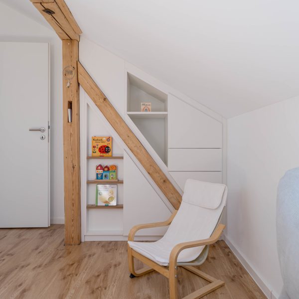 Sloped-Ceiling Cabinet with White Roof Beams