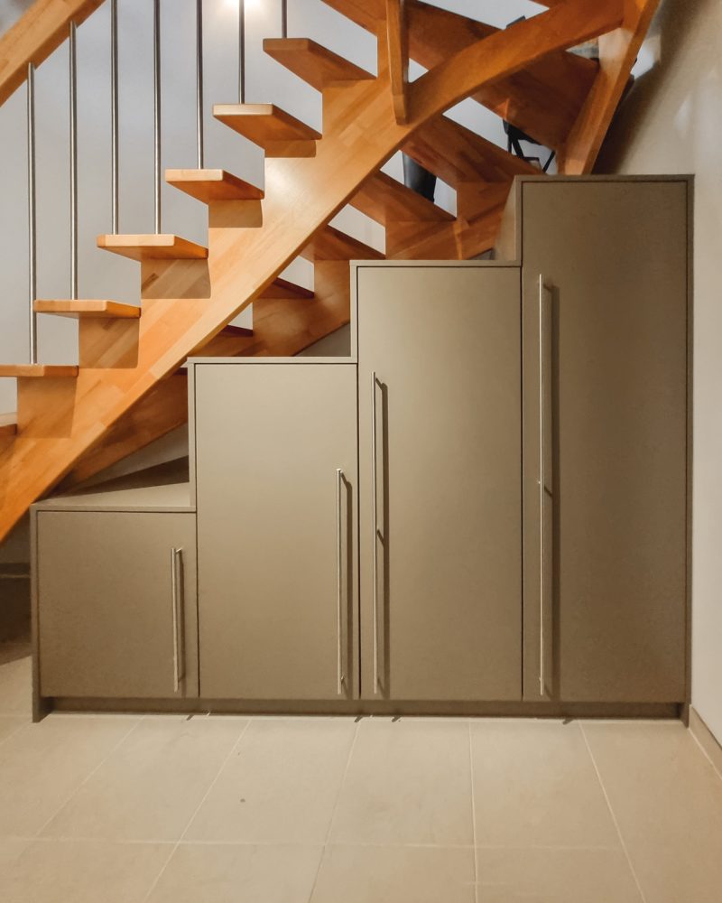 Staircase cupboard under a wooden staircase in gray