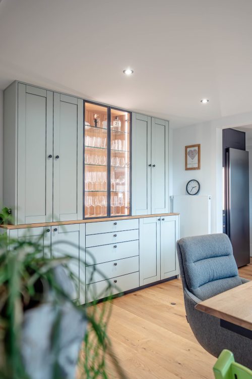 Sideboard in stone green with black edging, glass doors, and aluminum frame