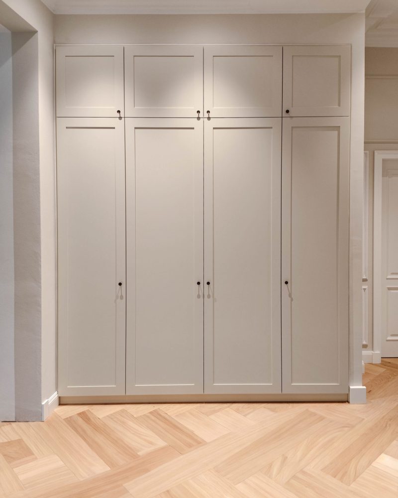 Custom-made beige fitted wardrobe with cassette front in the hallway