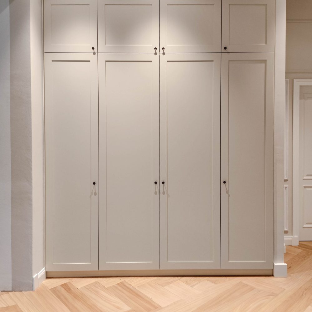 Custom-made beige fitted wardrobe with cassette front in the hallway