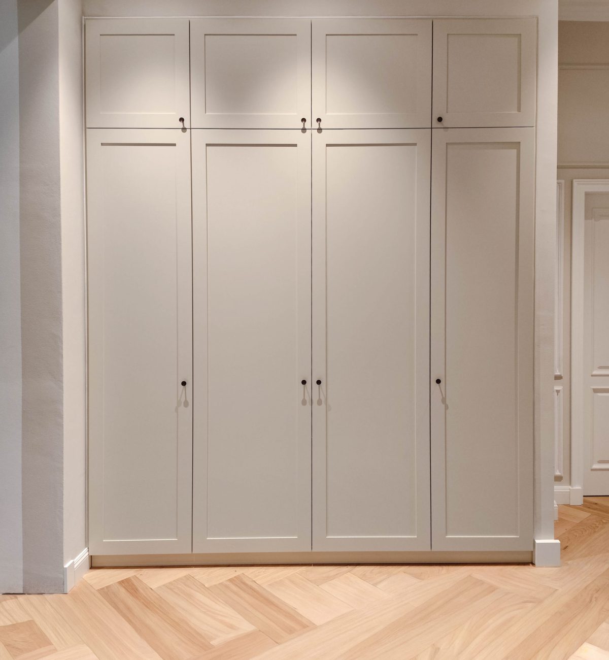Custom-made beige fitted wardrobe with cassette front in the hallway
