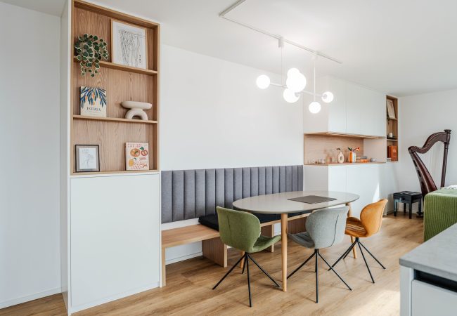 Matt white built-in cabinet with integrated dining area