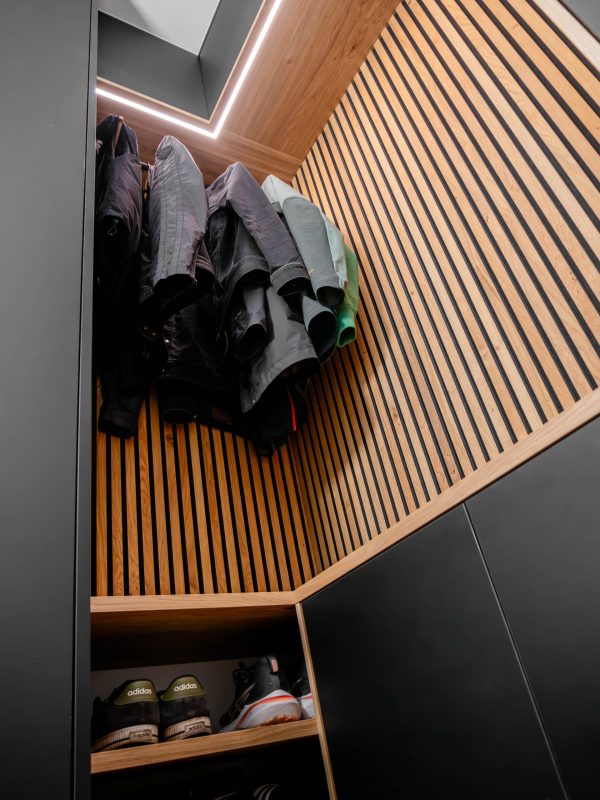 Wardrobe in matte black with oak panels and LED lighting