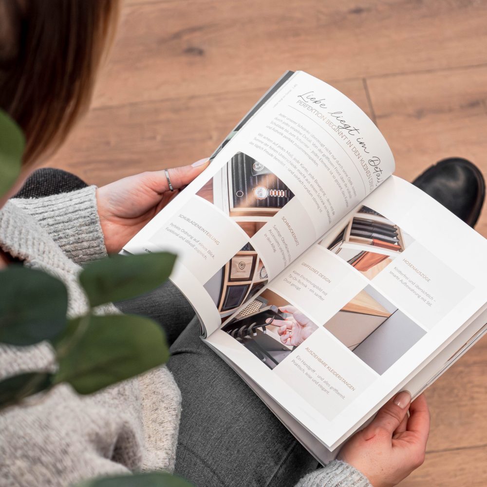 Opened Cabinetheroes magazine with detailed pictures in hand