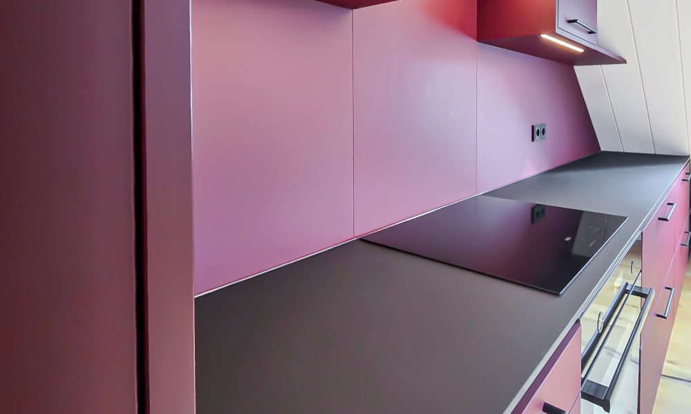 Fitted kitchen burgundy with LED lights above the worktop