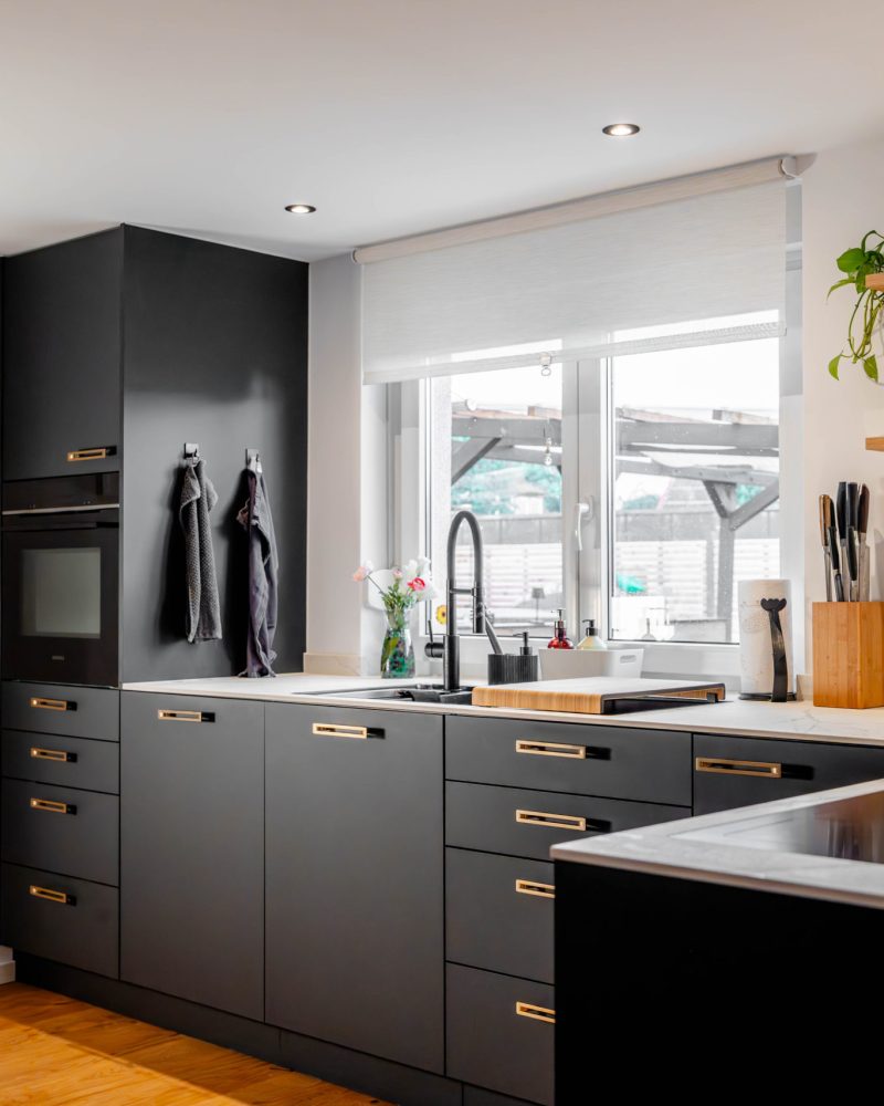 Matt black kitchen with integrated wine cabinet