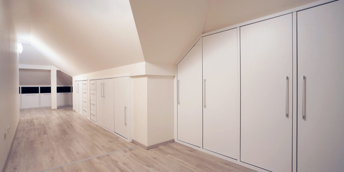 The interior of a simple, large closet.