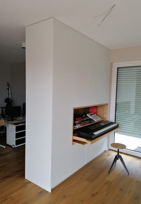 Room divider with a fold-out workstation that includes a keyboard