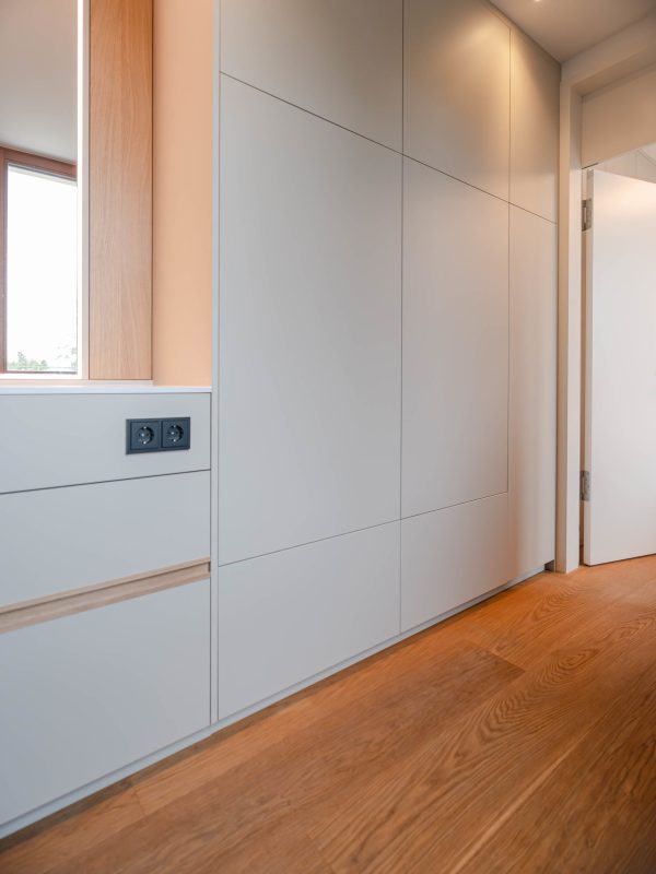 Beige bathroom cabinet with hidden washing machine compartment