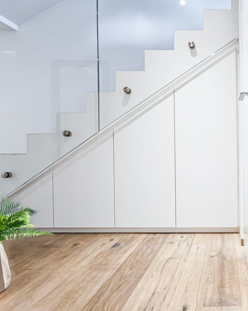 Staircase cupboard white matt shelf pull-outs