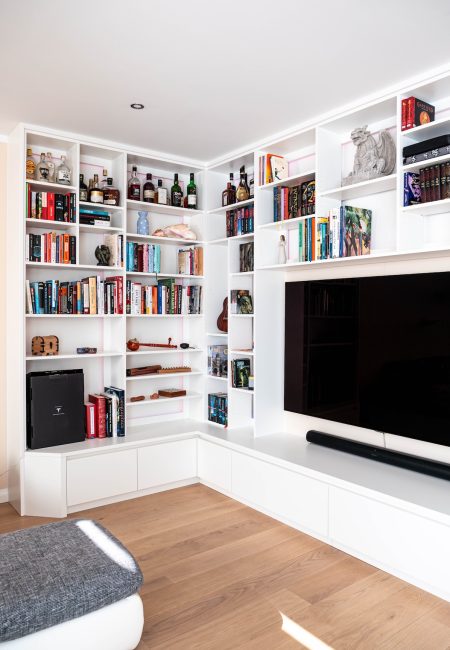 White wall unit around the corner with decorative elements
