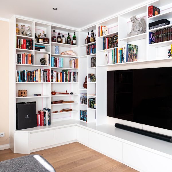 White wall unit around the corner with decorative elements