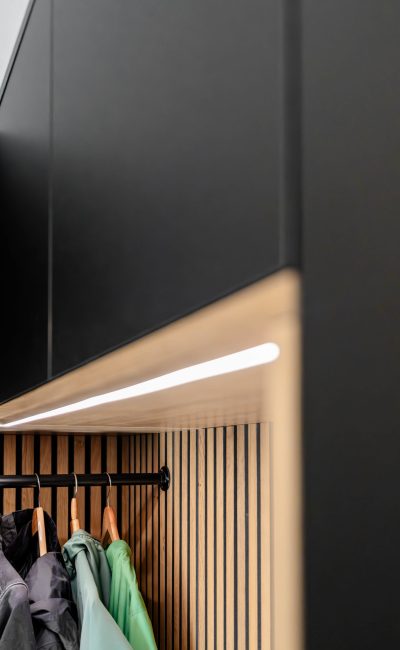 Matt black wardrobe with oak panels and LED lighting—side view of the LED strip
